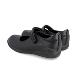 Pair of black leather Mary Jane school shoes with Velcro straps on white background