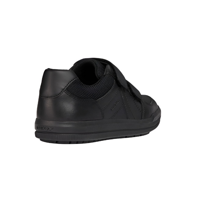Black leather boys' trainer with velcro strap and textured sole, rear side view