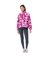 Woman wearing a pink and purple camouflage jacket with gray leggings on a white background