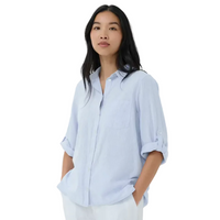 Woman wearing a light blue shirt against a white background
