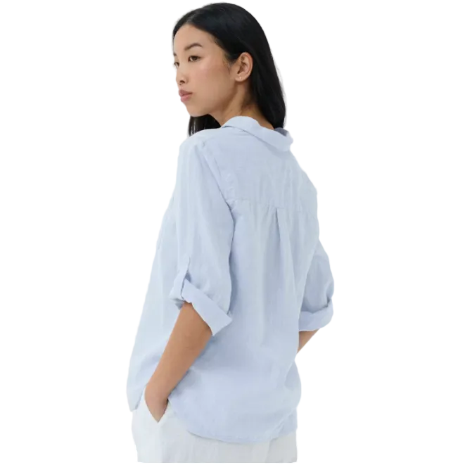 Woman wearing a light blue shirt against a white background