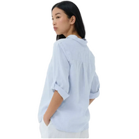 Woman wearing a light blue shirt against a white background