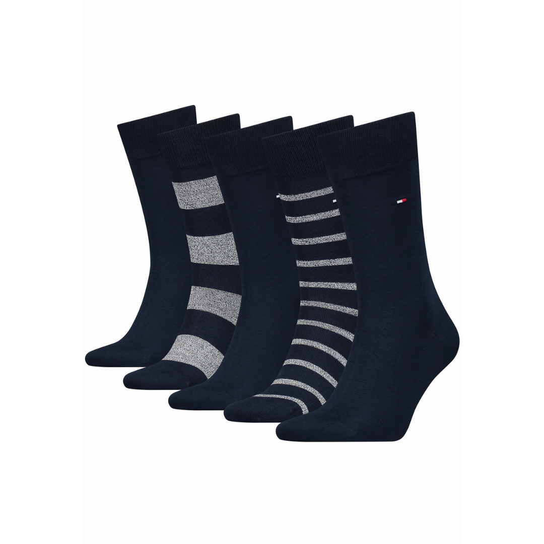 Set of five navy blue men’s socks, some plain, some with grey stripes, on white background